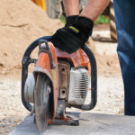 Construction Worker Cutting Stone With Circular Saw